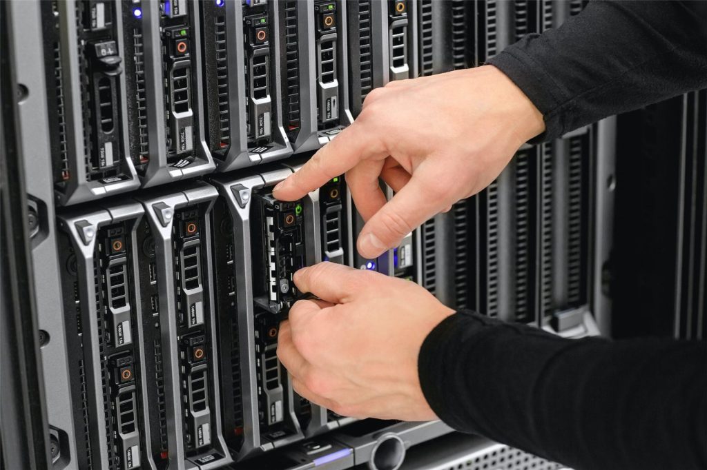 Technical consultant installing a blade server in a data centre